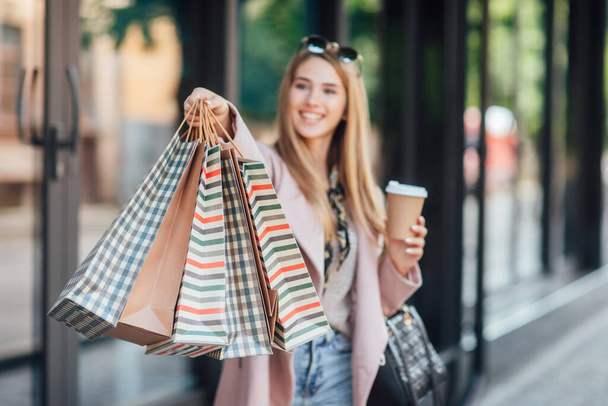 Close up photo. Street look, outfit. Woman with shopping package. Details. - Foto, Imagen