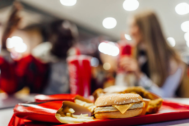 Fast food and unhealthy eating concept , close up of fast food snacks, burger and fries on the table. - Foto, Imagem