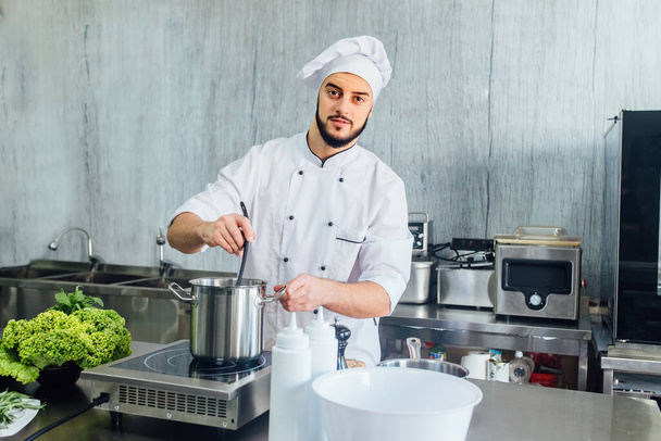 Chef preparing food in the modern restaurant kitchen, give the lesson how cooking italian spaghetti. - Φωτογραφία, εικόνα