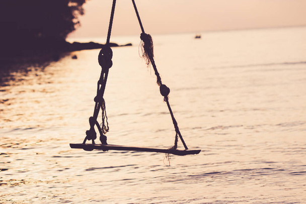 Wood swing on the beach in sunset summer. - Photo, Image