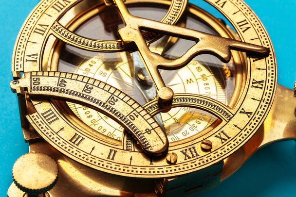 Compass on blue background, top view. creative photo. - Фото, изображение