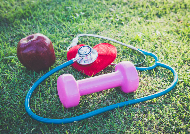Healthy concept with stethoscope,heart and red apple. - Photo, Image