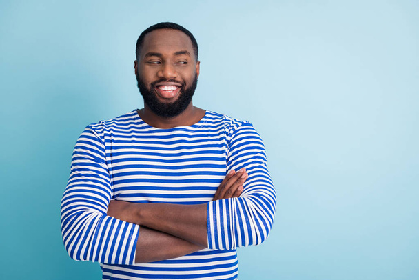 Portrait of cheerful afro american guy job sailor worker cross hands look copyspace listen to his friends colleagues wear trendy nautical vest frock isolated over blue color background - 写真・画像