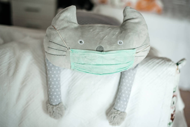 funny cat toy in medical mask, protected from corona virus - Фото, зображення