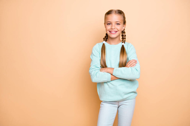 Photo of beautiful pretty small lady arms crossed best pupil of year self-confident school girl wear blue pullover jeans isolated beige pastel color background - Fotografie, Obrázek
