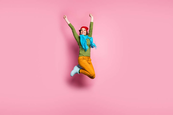 Full size photo of lovely sweet girl enjoy lottery victory success jump raise fists wear autumn style footwear outfit trousers sweater isolated over pink color background - Foto, immagini