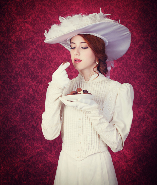 Beautiful redhead women with candy. - Photo, Image