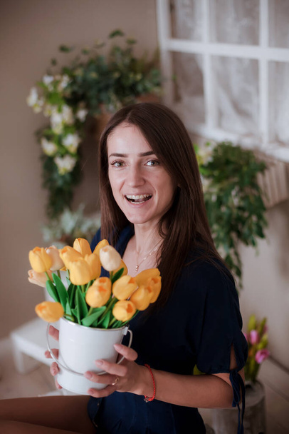 Portrait of   beautiful woman with yellow tulips.  - Photo, Image