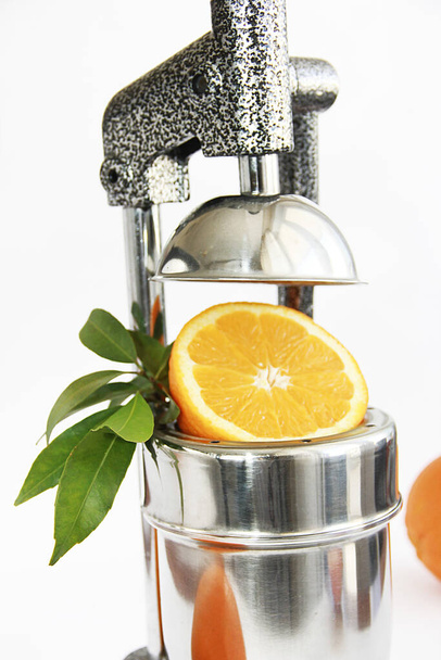 fruta naranja en rodajas naturales y exprimidor de fruta manual una prensa
 - Foto, imagen