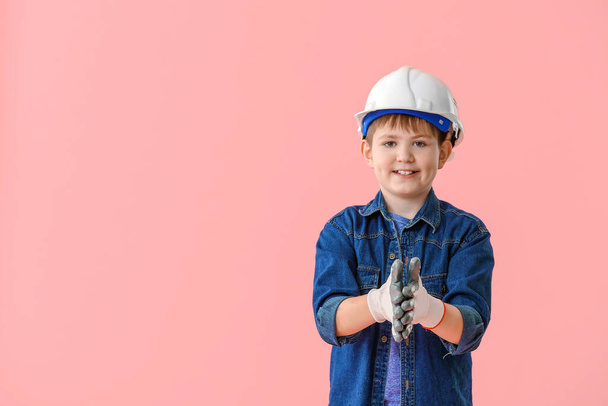 Cute little builder on color background - Фото, зображення