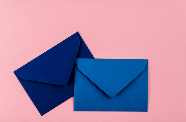 Blue envelopes on a pink background. Mail envelopes on the table. - Φωτογραφία, εικόνα
