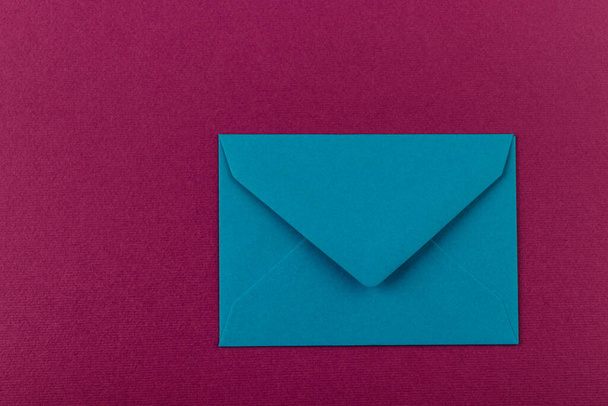 Colorful envelope on a purple background. Mail envelope on the table. - Foto, imagen