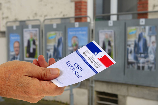 Election concept with a French voter card in front of electoral signs - Photo, Image