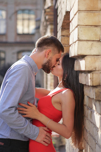 Beautiful couple of man and woman on the background of a wonderful architectural solution. Romantic theme with a girl and a guy. Spring, summer photo relationship, love, Valentine's day - Foto, immagini
