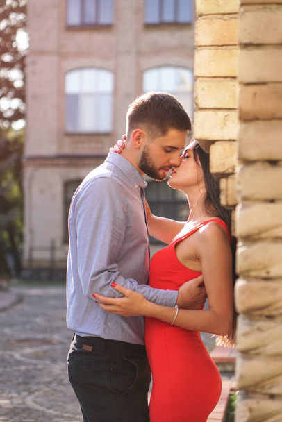 Beautiful couple of man and woman on the background of a wonderful architectural solution. Romantic theme with a girl and a guy. Spring, summer photo relationship, love, Valentine's day - Photo, Image