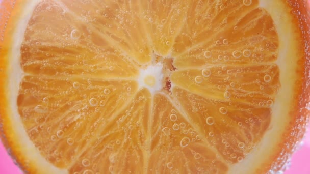 orange fruit, citrus vitamins . Orange slice and the external part close up. macro under water in water, fresh fruit for juice. bright juicy fruit, selective focus - Video