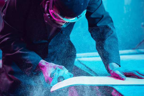 Skater in process of making his own skateboard, longboard - open business concept - 写真・画像