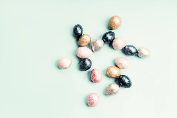 Colored painted pearl chicken and quail eggs of pink, silver, golden and blue - Photo, image