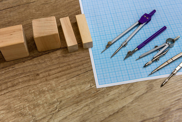 Millimeter paper with draw tools and wooden blocks - 写真・画像