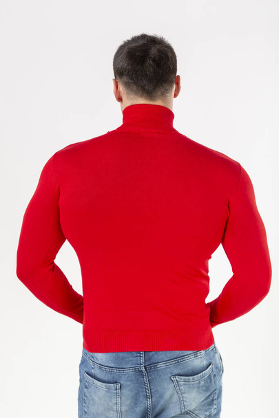 man in a red turtleneck with long sleeves on a white background, layout, copy of space - Φωτογραφία, εικόνα
