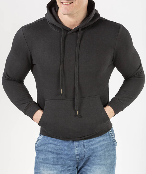 a man in a black hoodie and blue jeans on a white background - Fotoğraf, Görsel