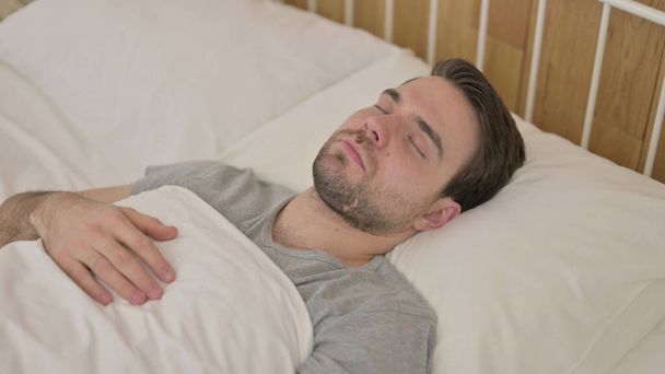 Tired Young Man having Nap in Bed - Foto, Imagem