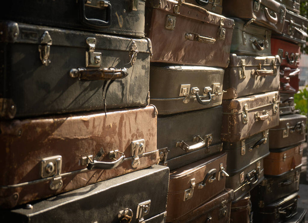 Vintage suitcases stacked in a heap - Fotó, kép