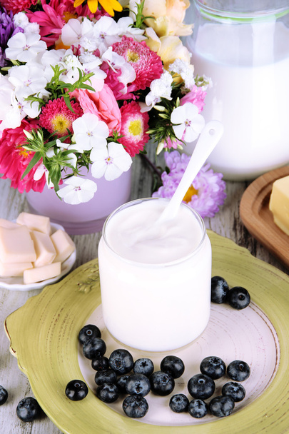 Fresh dairy products with blueberry on wooden table close-up - Foto, Imagem