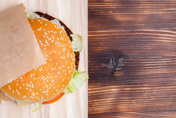 Burger top view from side on a wooden background. Close up. - Fotoğraf, Görsel