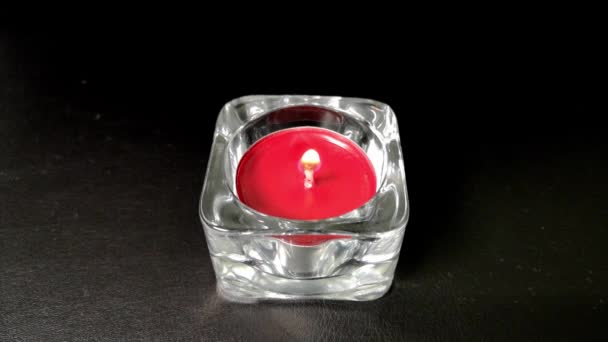 Match igniting a red candle, then the wind blow it out. Smoke. Black background. - Footage, Video