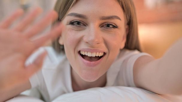 Close up of Cheerful Young Woman doing Video Chat in Bed - Photo, Image