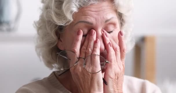Tired senior woman taking off eyeglasses feeling eye strain concept - Footage, Video
