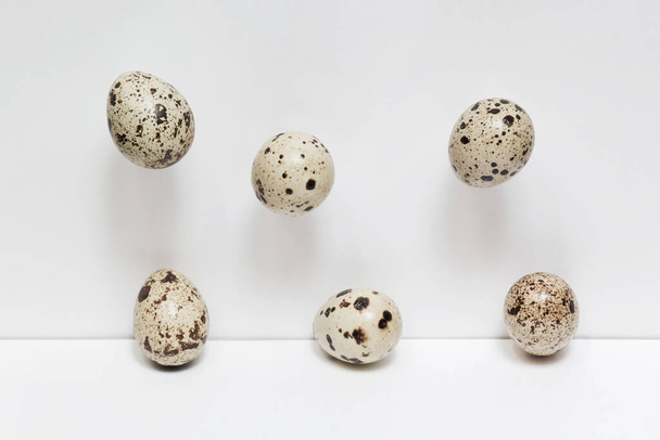 Quail egg composition on white background. Minimal food art, Scandinavian style. Food levitation - Photo, Image