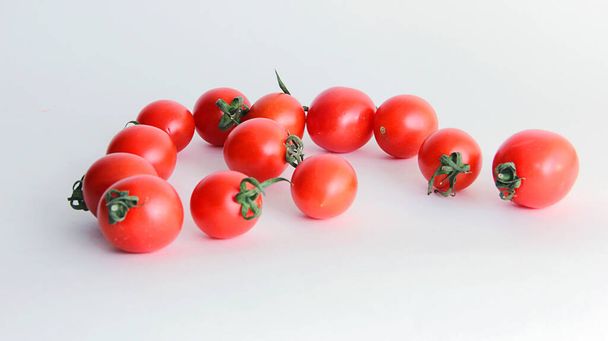 Fresh  red tomatoes cherry in a bowl isolated on white - 写真・画像