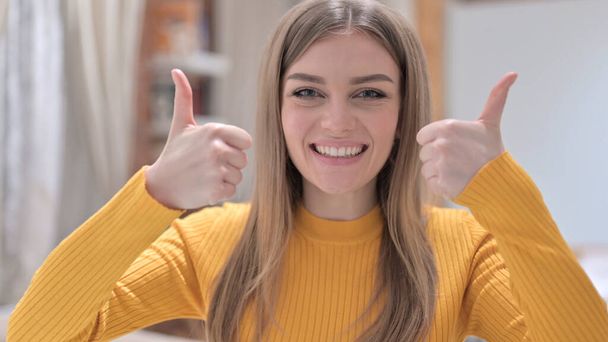 Portrait of Young Woman showing Thumbs Up with Two Hands - Foto, Bild