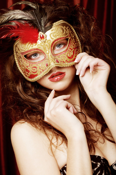 Young woman in a red mysterious mask - Foto, imagen