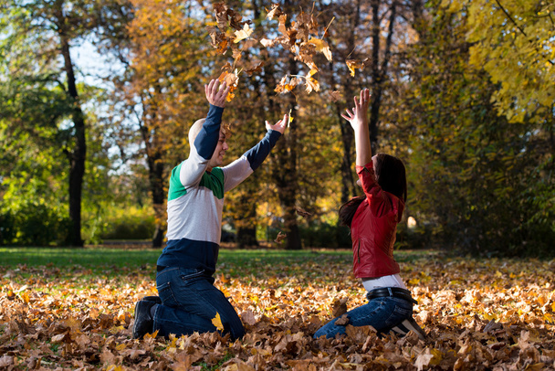 Couple Having Fun With Autumn Leaves In Garden - Photo, Image