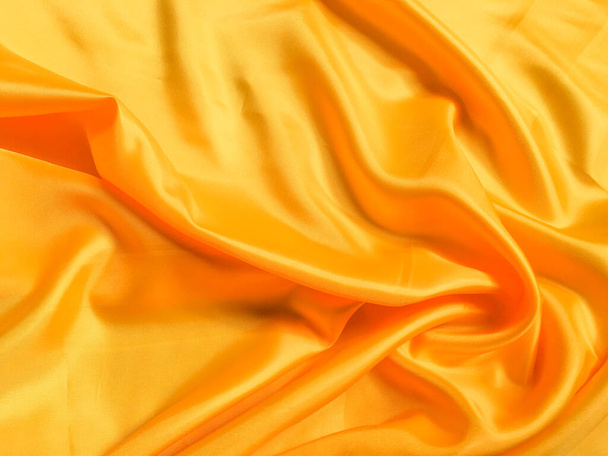 Yellow silk or satin texture background with copy space for design - Foto, Bild