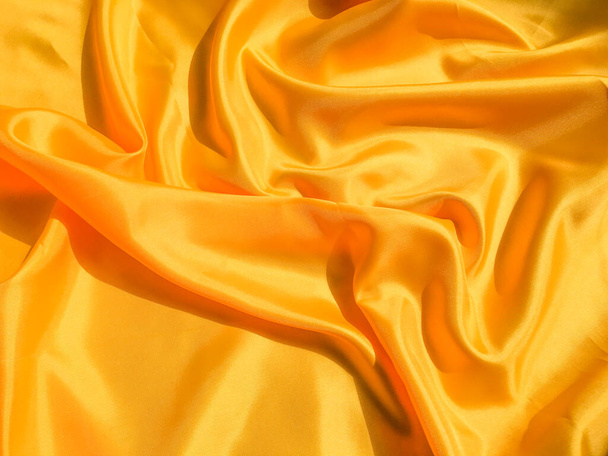 Yellow silk or satin texture background with copy space for design - Фото, зображення