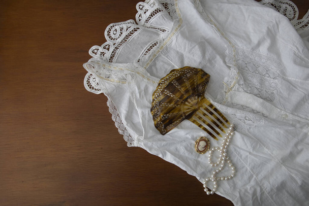 Vintage underwear and jewelry laid out on a wooden surface  - Photo, Image