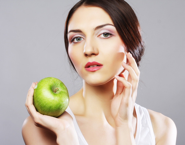 Young woman with green apple - Фото, зображення