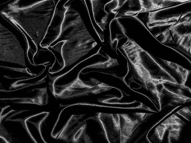 流動波や波状の折り目を持つ豪華な黒い絹やサテンのテクスチャの背景。壁紙デザイン - 写真・画像