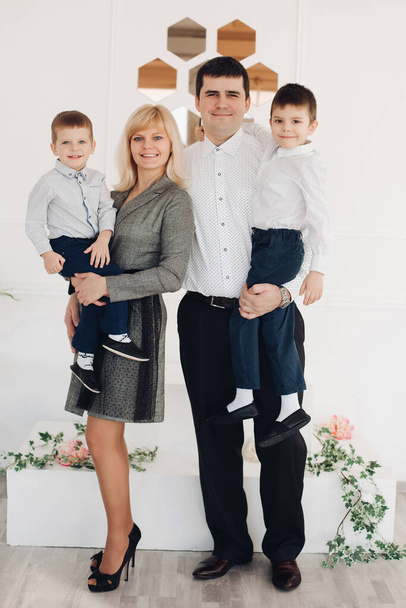 Happy young family standing with little sons - Фото, зображення