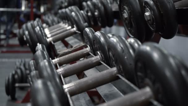Video rack with dumbbells in fitness gym - Video