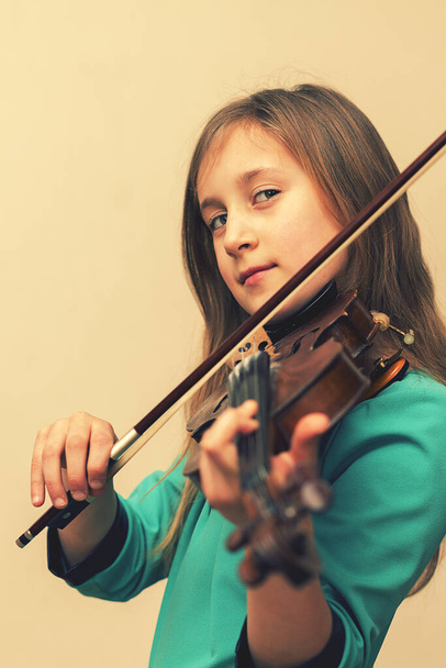 cute girl in a blue dress with a violin. toned. vertical photo. toned. - Fotografie, Obrázek
