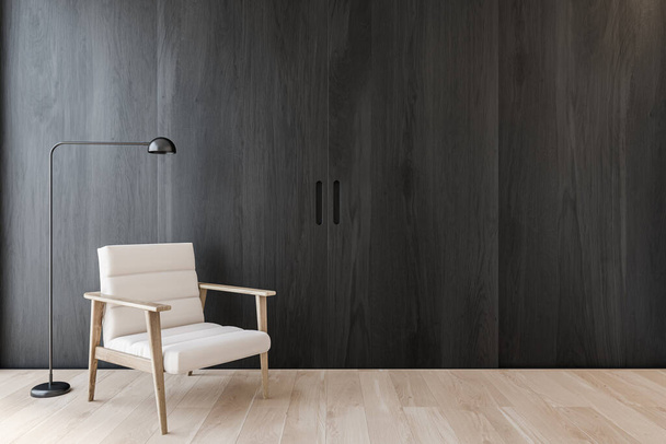 Εσωτερικό μινιμαλιστικό σαλόνι με σκούρους ξύλινους τοίχους, ξύλινο δάπεδο, άνετη λευκή πολυθρόνα με φωτιστικό δαπέδου και συρόμενη πόρτα. Έννοια της χαλάρωσης. 3d απόδοση - Φωτογραφία, εικόνα