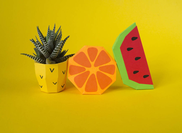 Tropical fruits made of paper. Pineapple flower in a pot. Volumetric paper plastic. - Foto, Imagen