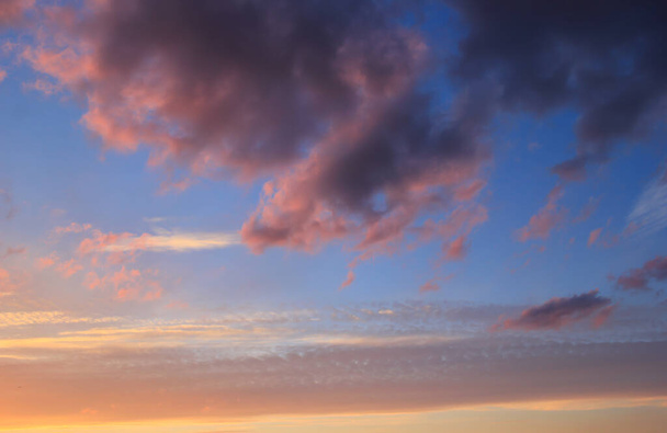 Lente blauwe lucht bij zonsondergang met grijze wolken. - Foto, afbeelding