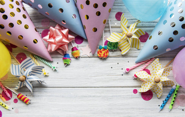 Happy birthday or party background.  Flat Lay wtih birthday hats, confetti and ribbons on white wooden background. Top View.  Copy space. - Foto, Imagem