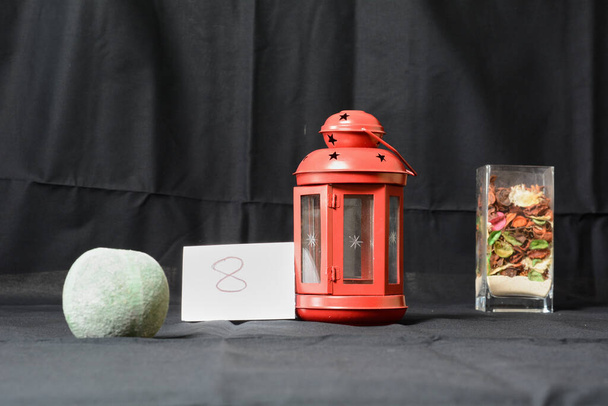 Red lantern With bowl with sand. Photographic opening exercise aperture - Photo, Image